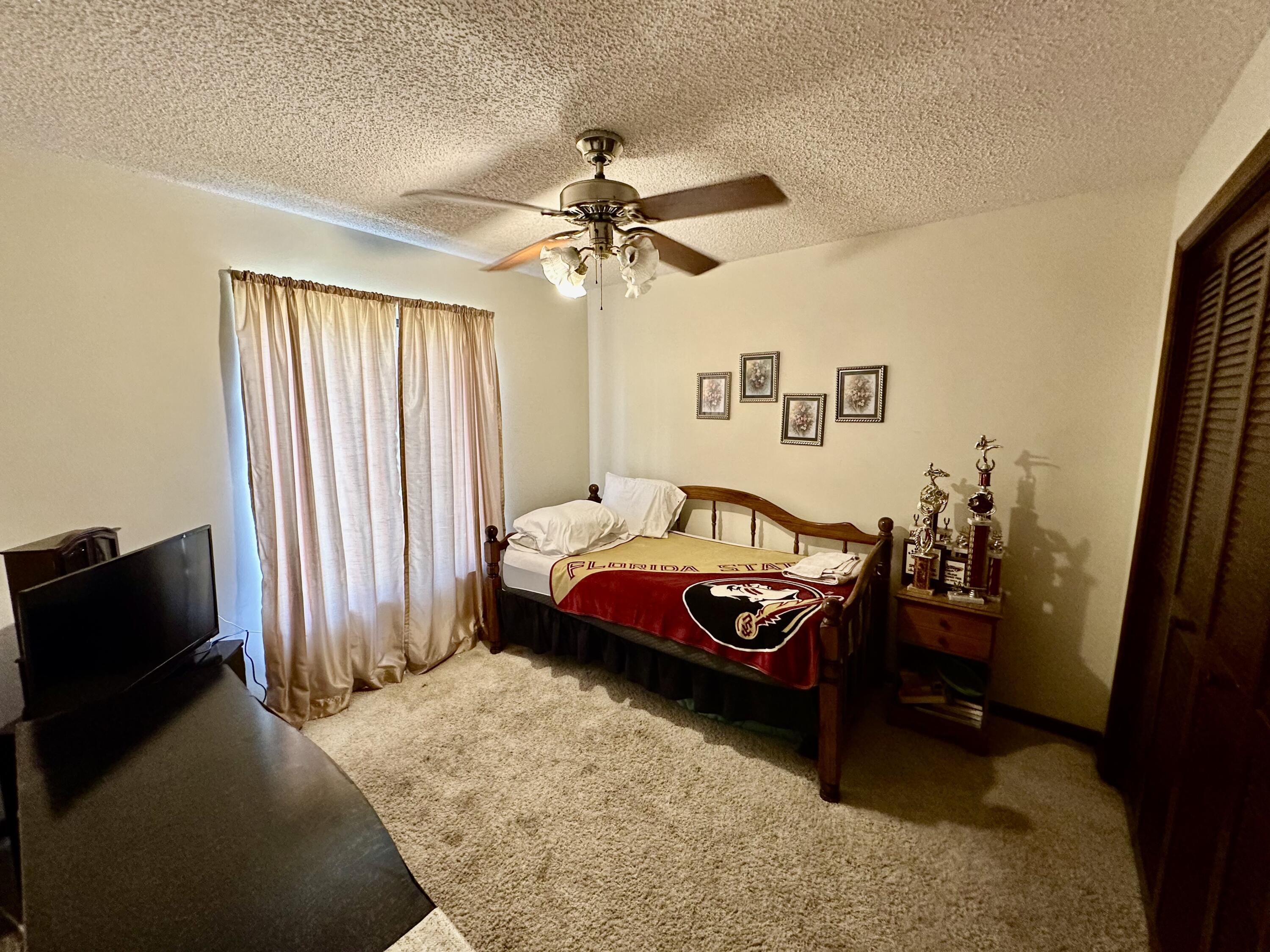 4980 Bridge Road Cocoa, FL 32927 - Photo 19 of 24 a bedroom with furniture and a window