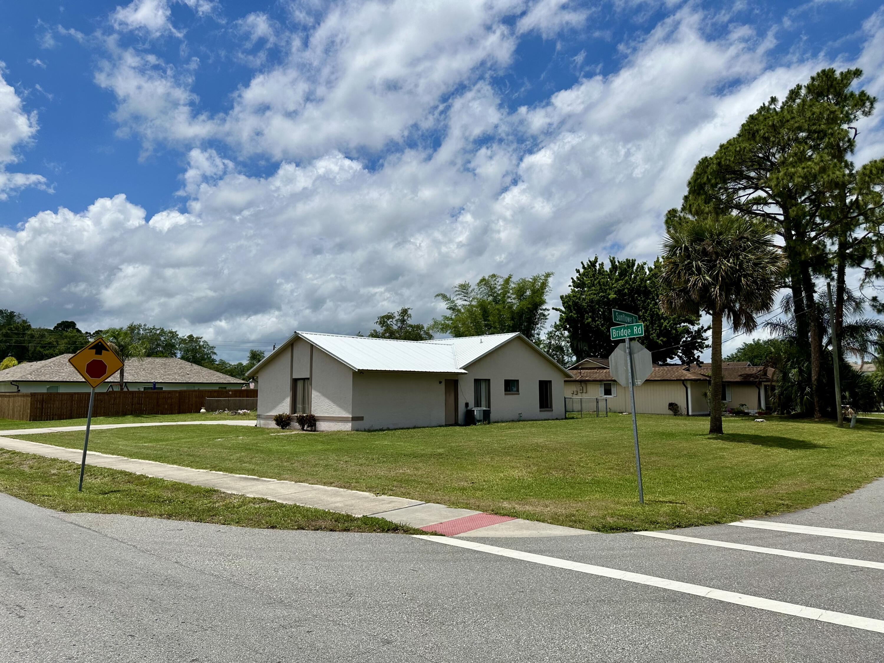 4980 Bridge Road Cocoa, FL 32927 - Photo 4 of 24 a view of a house with a big yard and large trees