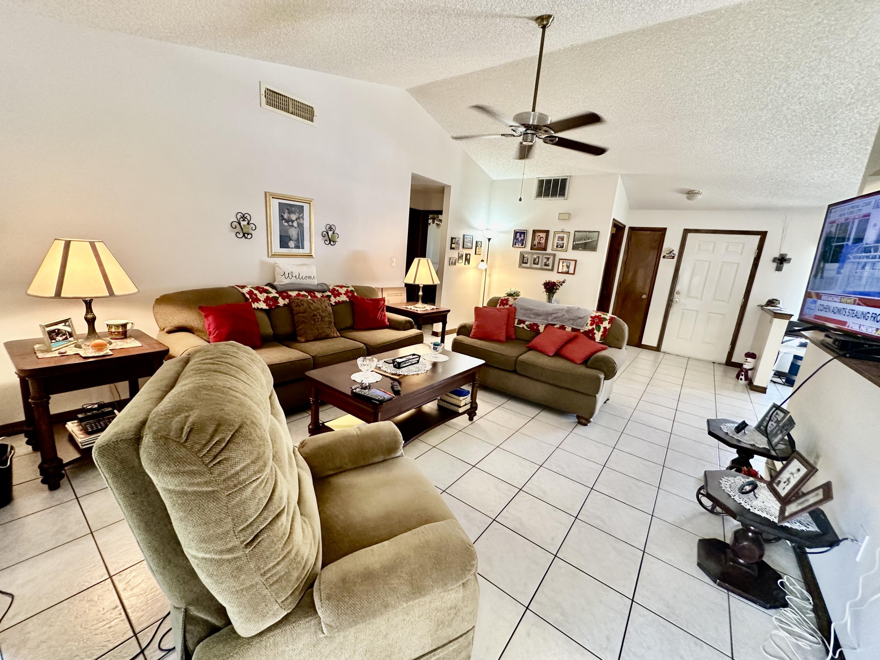 4980 Bridge Road Cocoa, FL 32927 - Photo 9 of 24 a living room with furniture and a flat screen tv