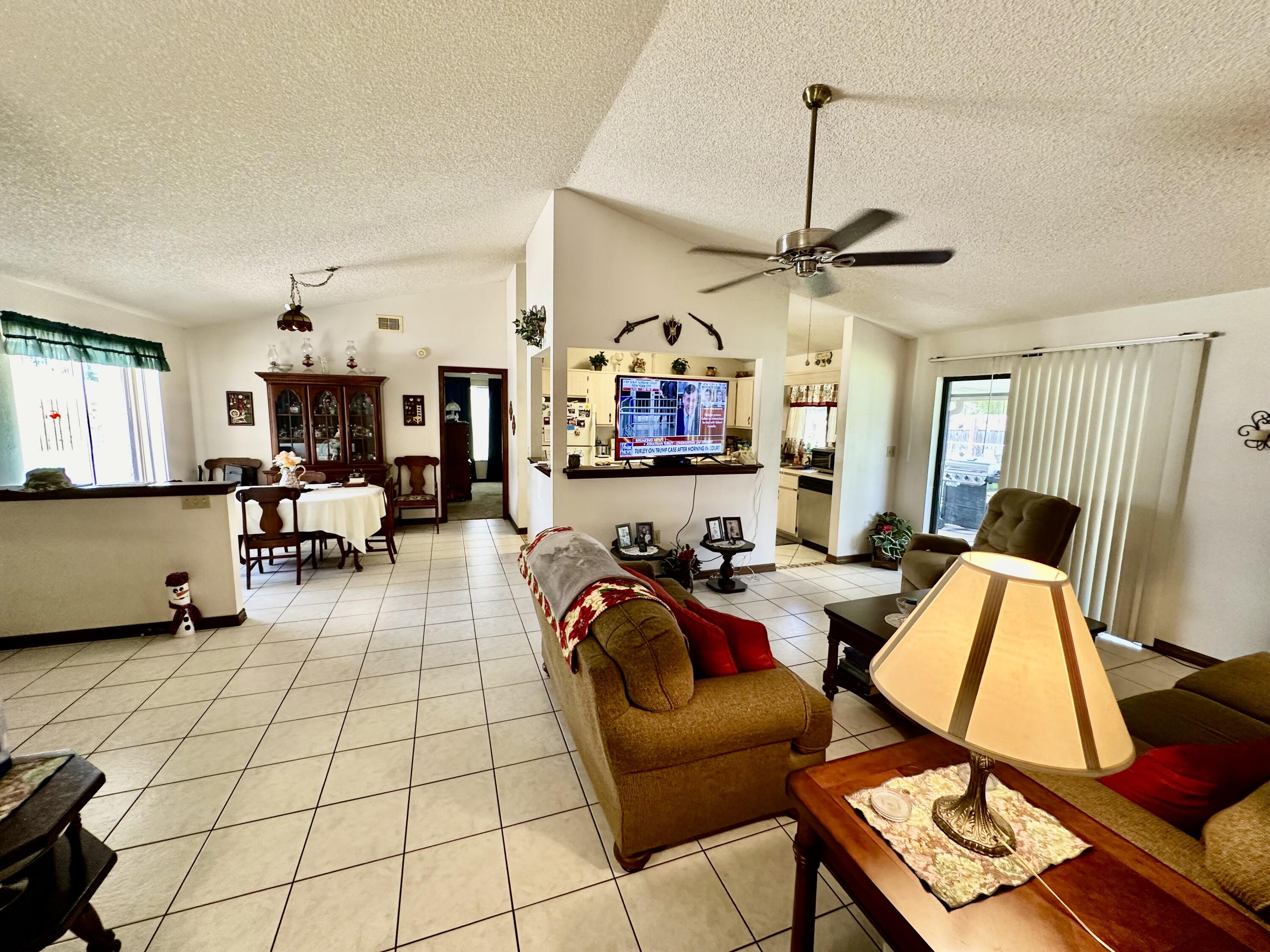 4980 Bridge Road Cocoa, FL 32927 - Photo 10 of 24 a view of a livingroom with furniture and a flat screen tv