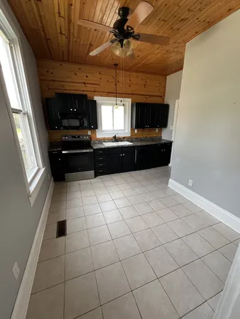 a kitchen with granite countertop a sink and a counter top space