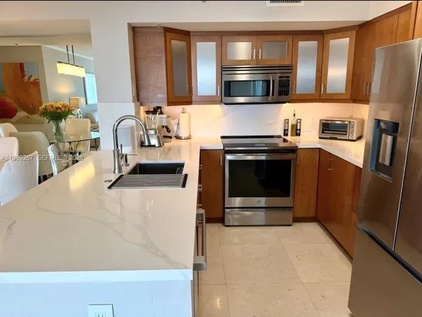 a kitchen with stainless steel appliances a stove a microwave and a refrigerator
