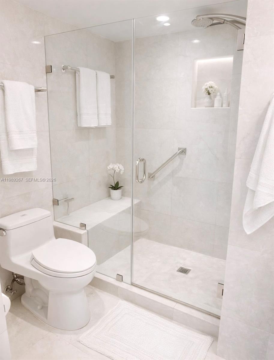 90 Alton Road, Unit 803 Miami Beach, FL 33139 - Photo 15 of 23 a bathroom with a toilet and a shower