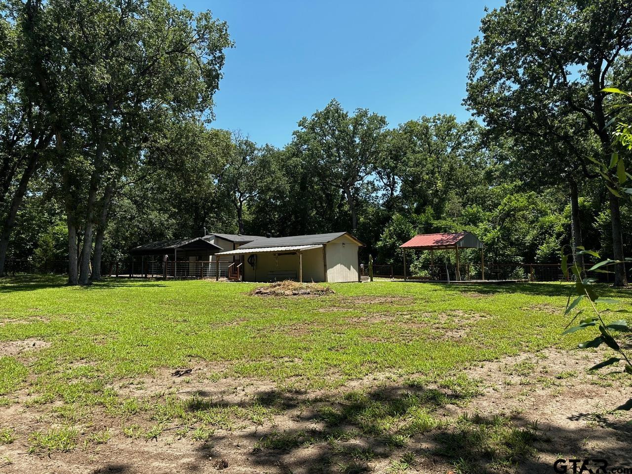 223 Holly Glen Murchison, TX 75778 - Photo 27 of 34 a blue swimming pool is in the middle of a yard