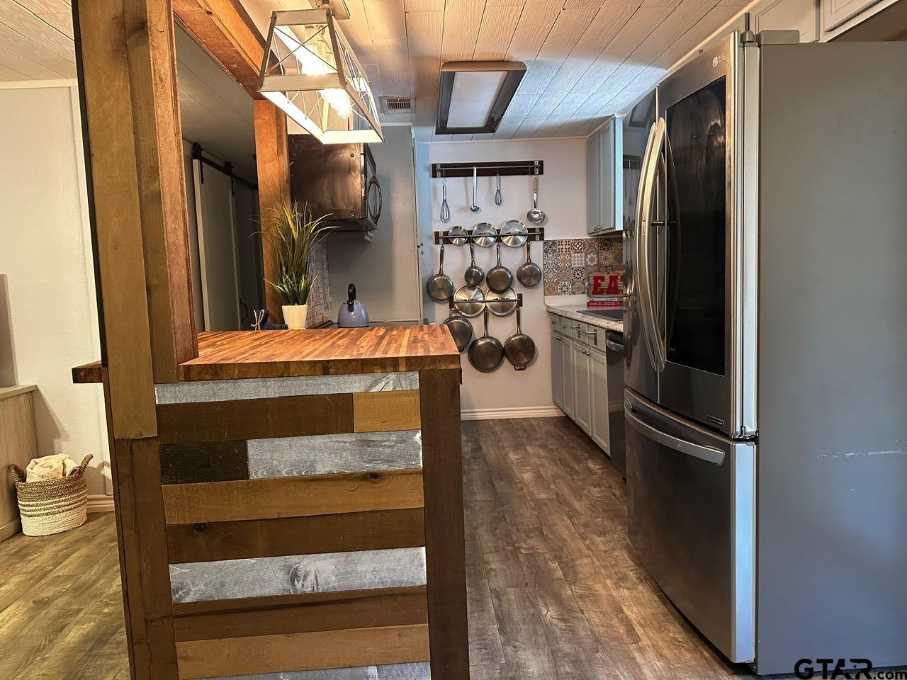 223 Holly Glen Murchison, TX 75778 - Photo 6 of 34 a kitchen with a refrigerator and cabinets