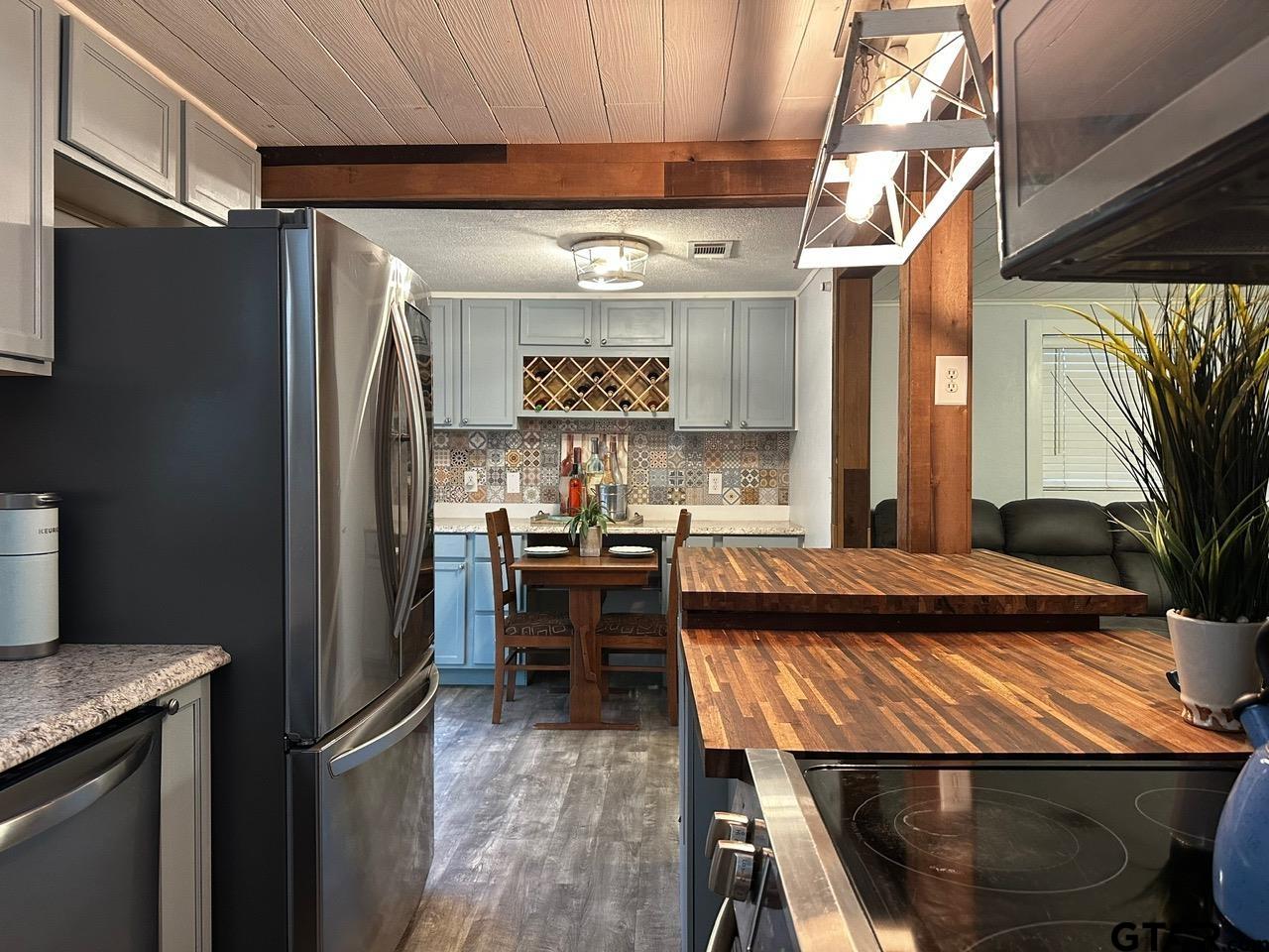 223 Holly Glen Murchison, TX 75778 - Photo 7 of 34 a kitchen with stainless steel appliances granite countertop a refrigerator and a stove