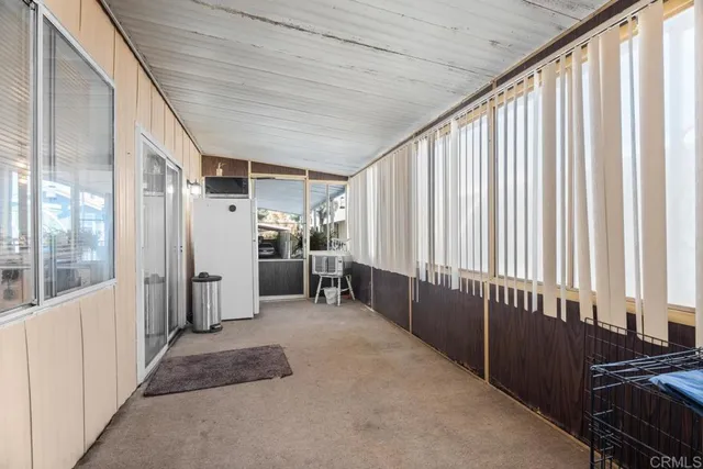 a living room with furniture and large windows