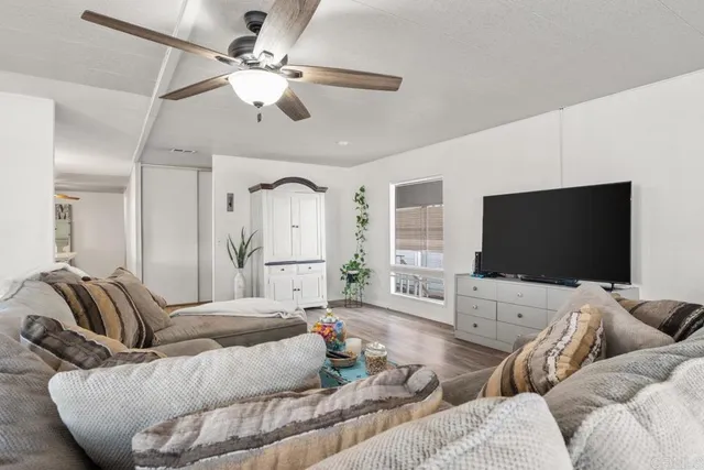 a living room with furniture and wooden floor
