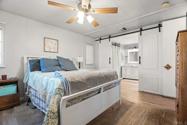 a spacious bedroom with a bed and a chandelier