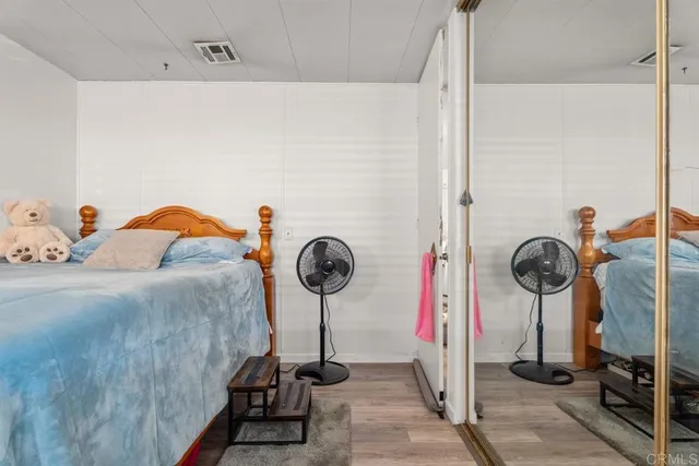 a bed room with a bed and a flat tv screen