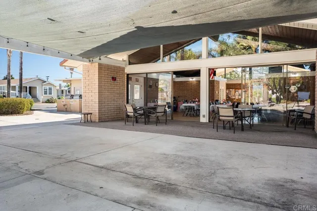 a large white kitchen with granite countertop a sink and a large mirror