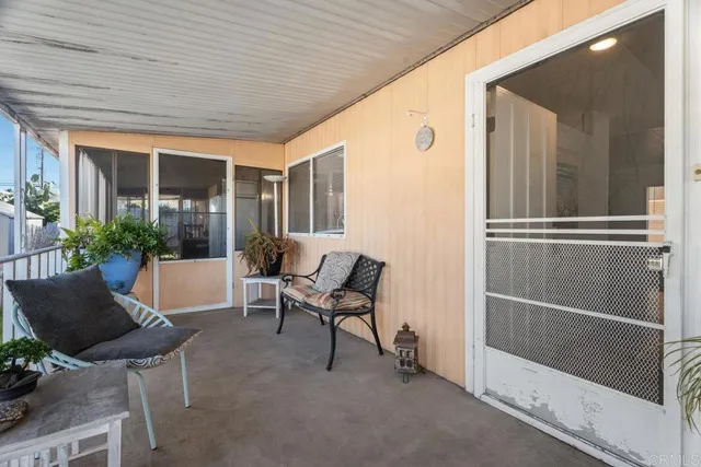 a balcony with furniture and potted plants