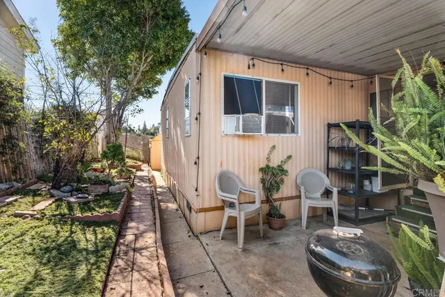 a backyard of a house with outdoor seating