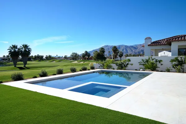 a view of house with backyard outdoor seating and hardwood
