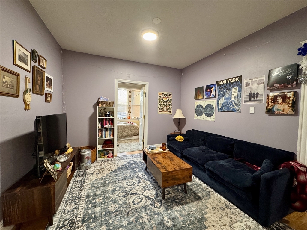 a living room with furniture gym equipment and a flat screen tv
