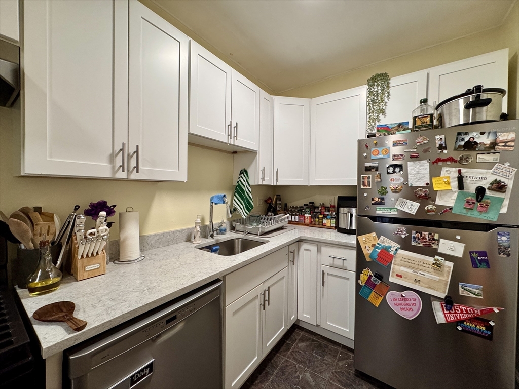50 Chester Street, Unit 10 Boston, MA 02134 - Photo 3 of 13 a kitchen with stainless steel appliances granite countertop a sink and cabinets
