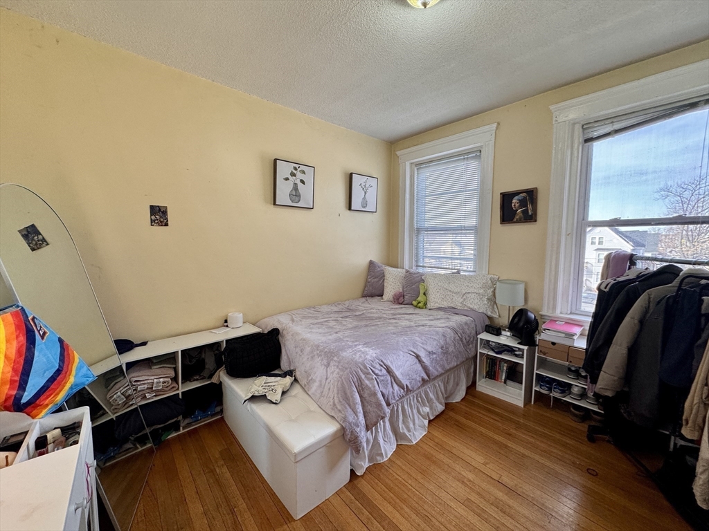 50 Chester Street, Unit 10 Boston, MA 02134 - Photo 5 of 13 a bedroom with a bed and a couch