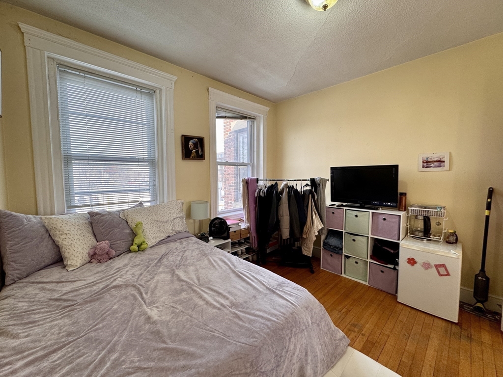 50 Chester Street, Unit 10 Boston, MA 02134 - Photo 6 of 13 a bedroom with a bed and a flat screen tv