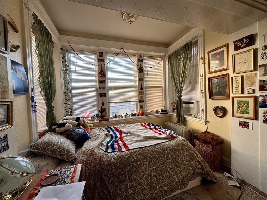 50 Chester Street, Unit 10 Boston, MA 02134 - Photo 8 of 13 a bedroom with furniture and a window