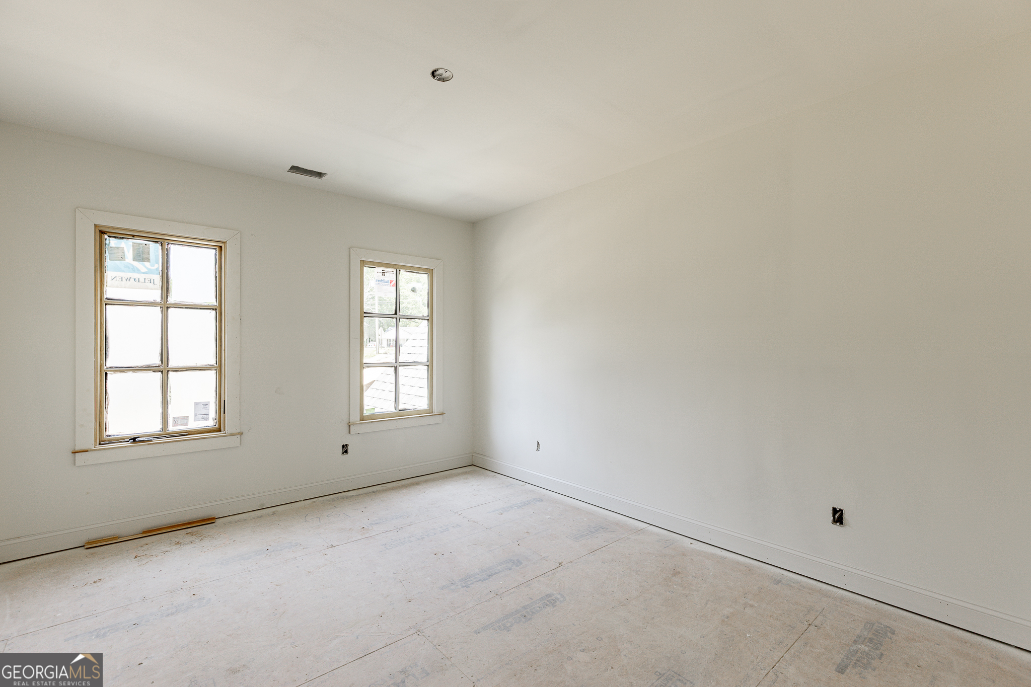 2969 North Bogan Road Northeast, Unit 1 Buford, GA 30519 - Photo 28 of 51 an empty room with windows