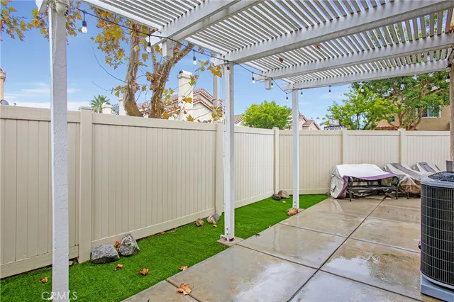 a view of a patio with table and chairs and potted plants