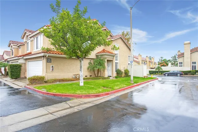 a front view of a house with a garden and plants