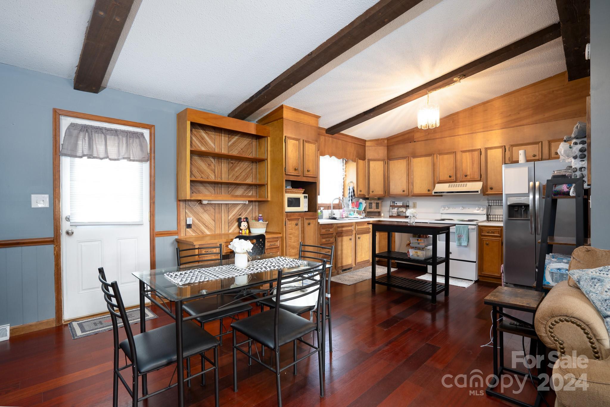 130 Log Barn Road Salisbury, NC 28146 - Photo 6 of 22 a dining room with stainless steel appliances kitchen island granite countertop a dining table and chairs with wooden floor