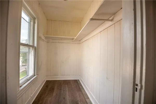 a view of a room with a window and a ceiling fan