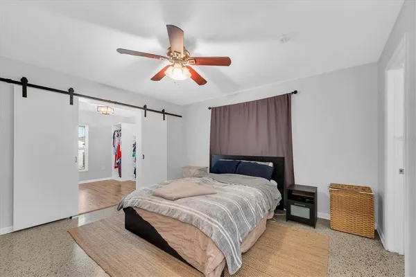 a bedroom with a bed and a chandelier