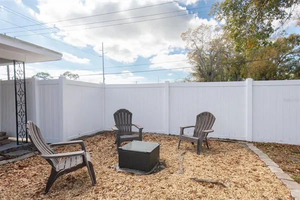a table and chair sitting in backyard of a house