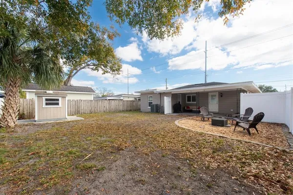 a view of a house with backyard and sitting area