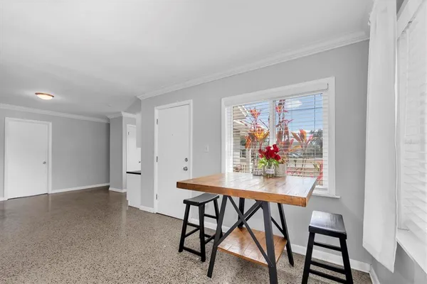 a dining room with furniture and window