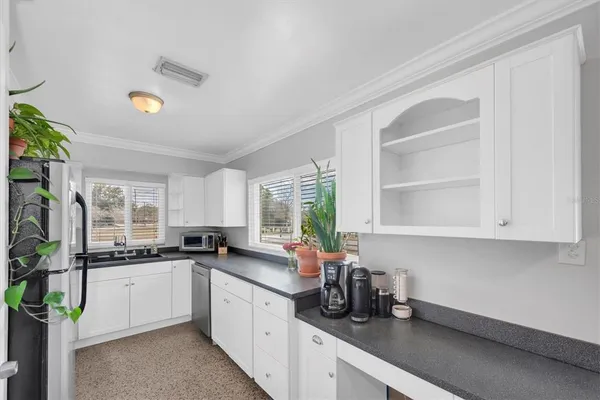 a kitchen with a sink cabinets and window