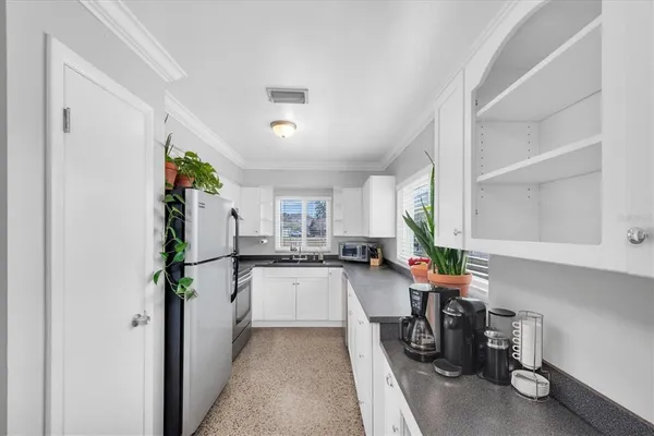 a kitchen with sink refrigerator and stove