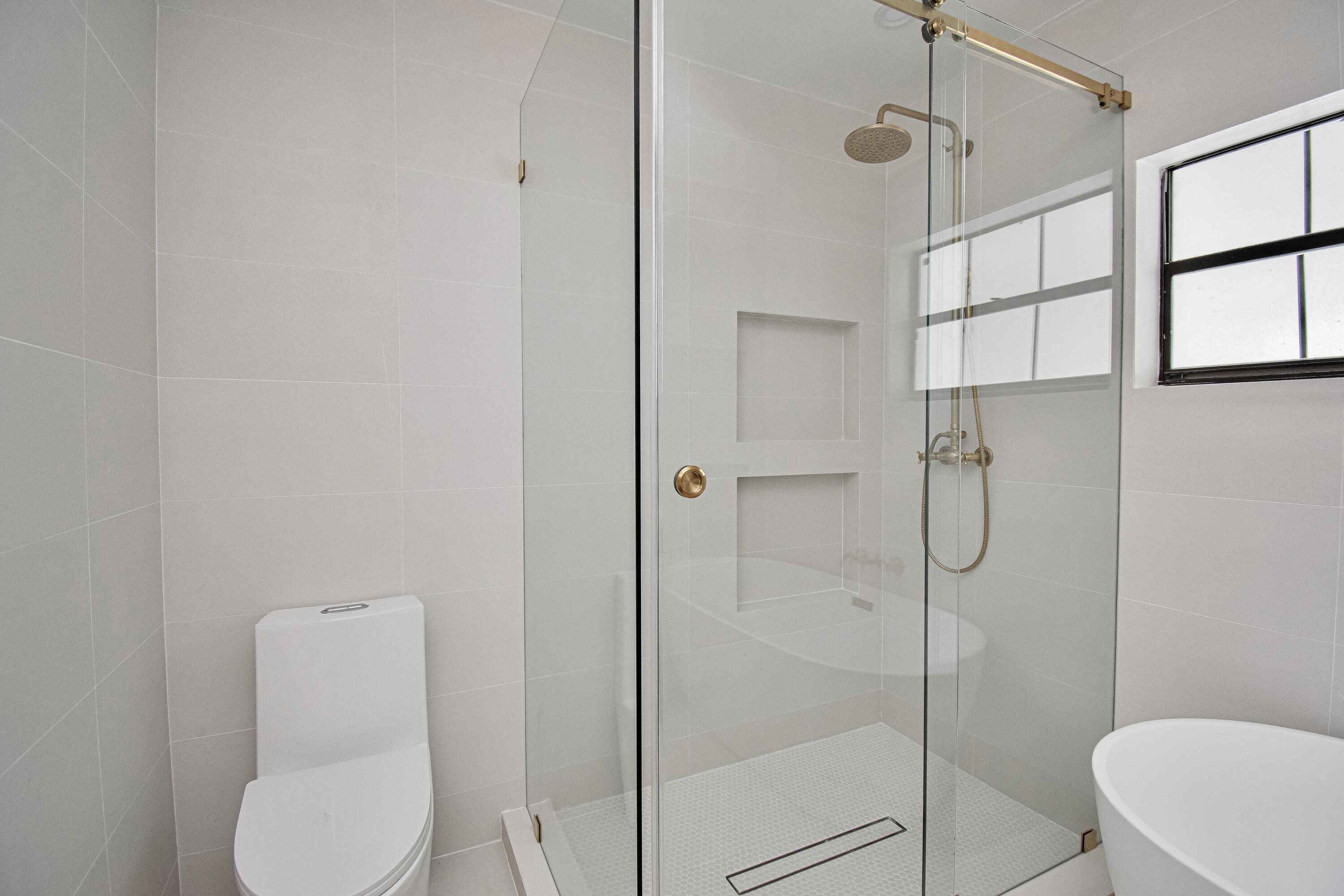 a bathroom with a toilet and shower