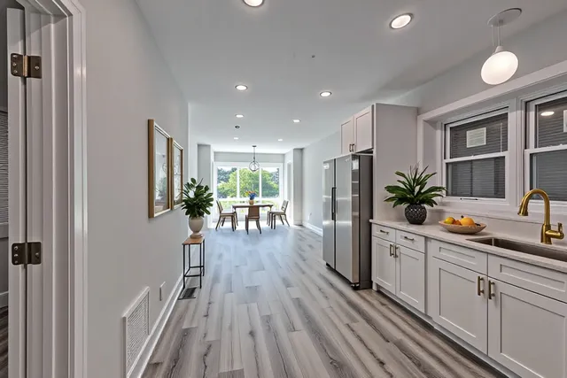 a kitchen with white cabinets and stainless steel appliances