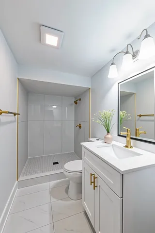 a bathroom with a sink a toilet and mirror