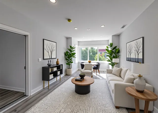 a living room with furniture and a potted plant
