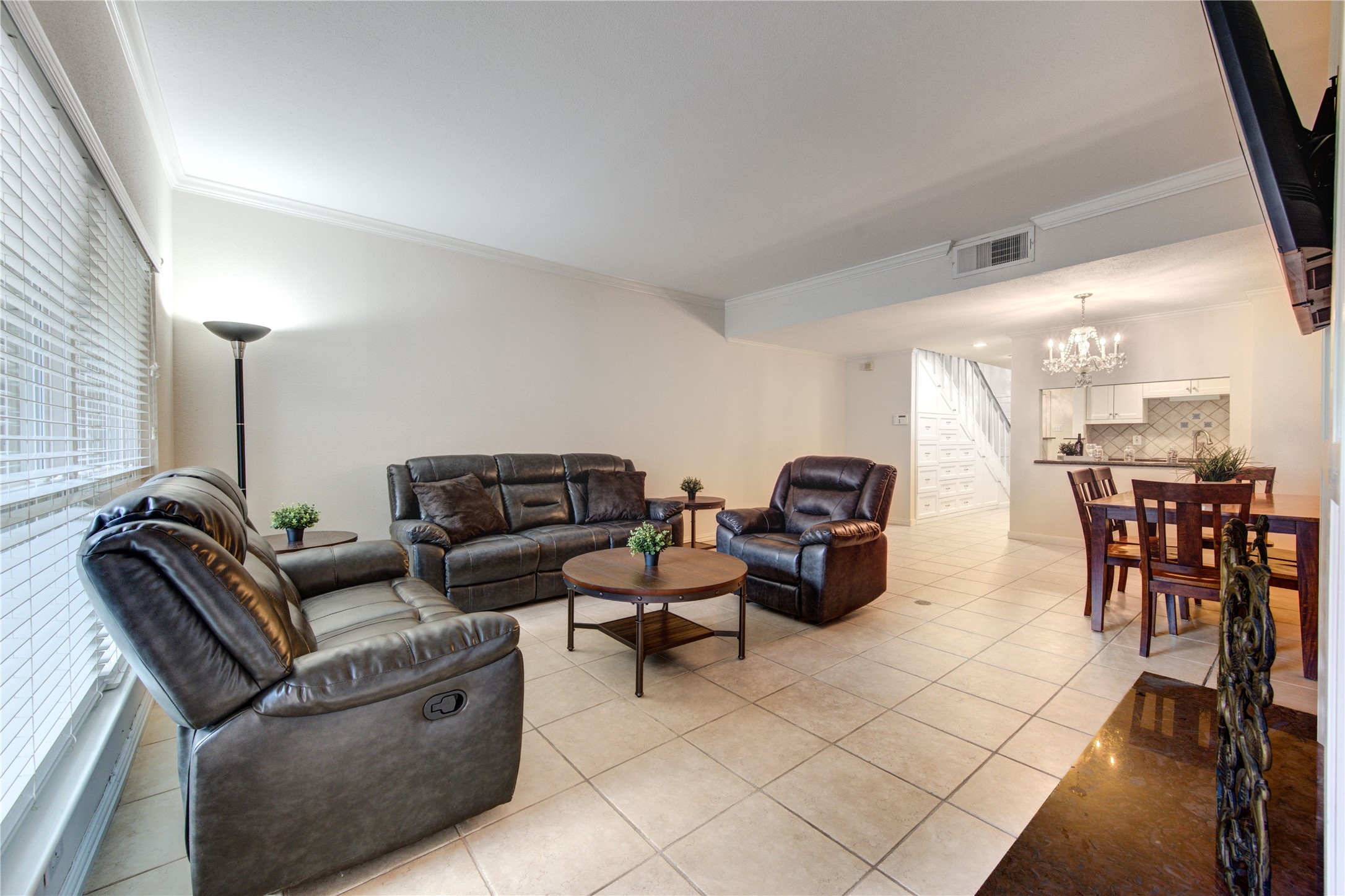 2232 South Piney Point Road, Unit 110 Houston, TX 77063 - Photo 7 of 21 Inviting living room filled with natural light, offering an open layout that flows seamlessly into the dining area and kitchen.