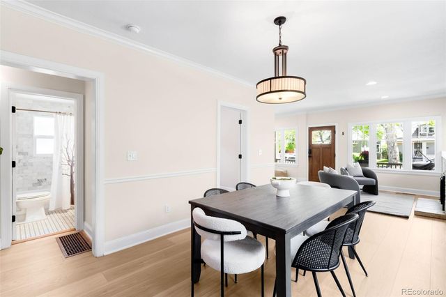 a view of a dining room with furniture window and wooden floor