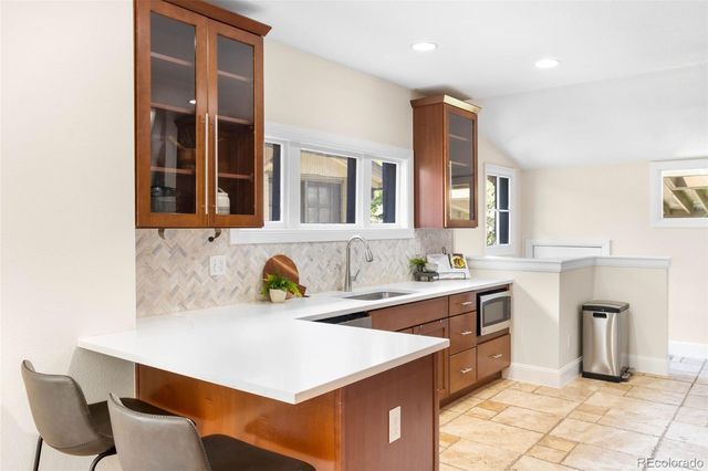 a kitchen with a sink cabinets and window