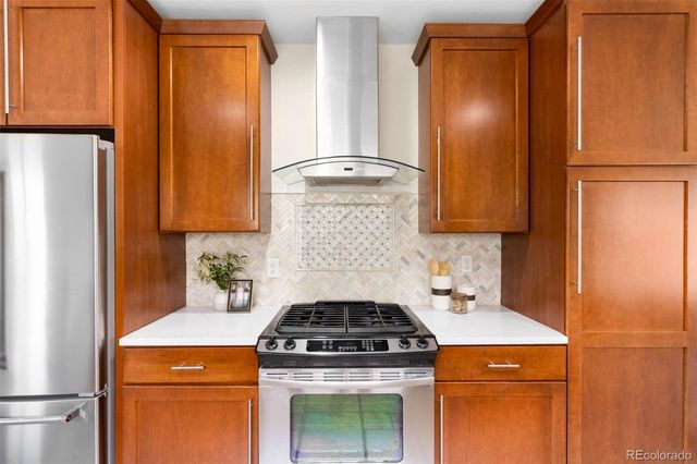 a stove top oven sitting inside of a kitchen