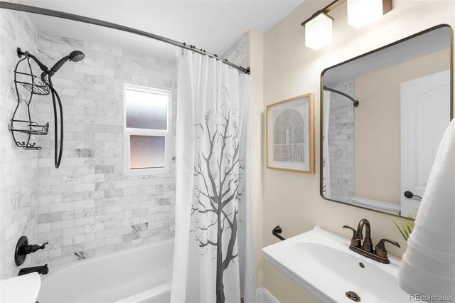 a bathroom with a sink a mirror and a shower