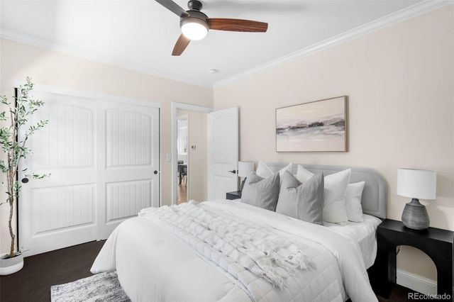 a bedroom with a bed and a painting on the wall