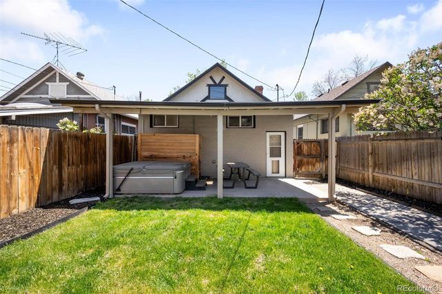a view of a house with a yard and sitting area