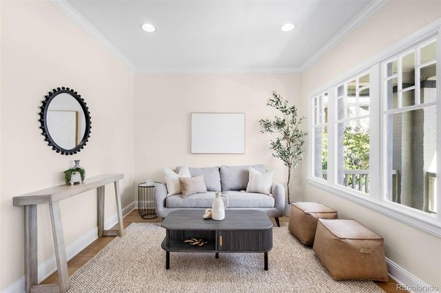 a living room with furniture a window and a potted plant