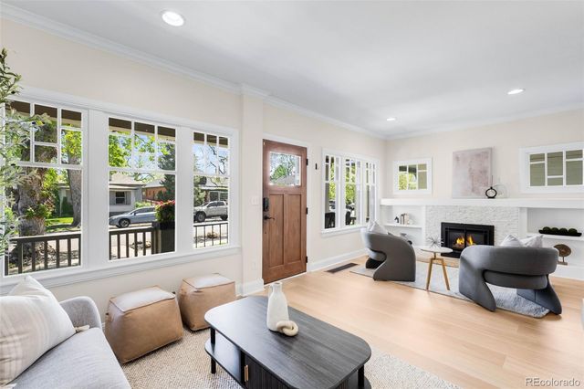 a living room with furniture fireplace and a large window