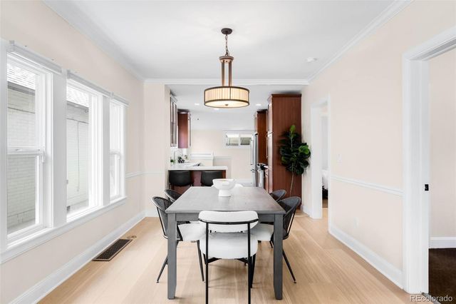 a view of a dining room with furniture window and wooden floor