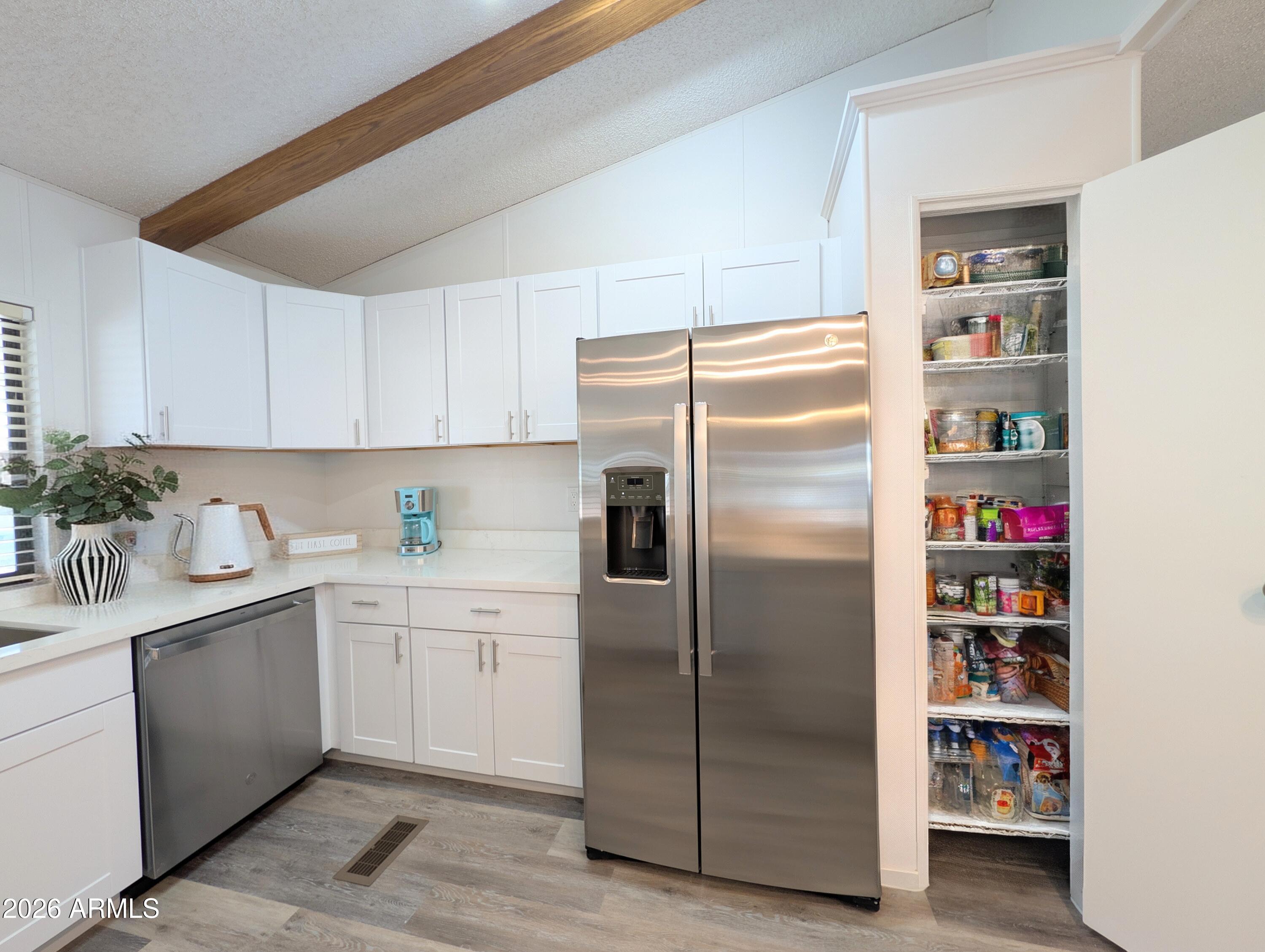 512 South 83rd Way Mesa, AZ 85208 - Photo 17 of 45 a kitchen with stainless steel appliances granite countertop a refrigerator and a sink