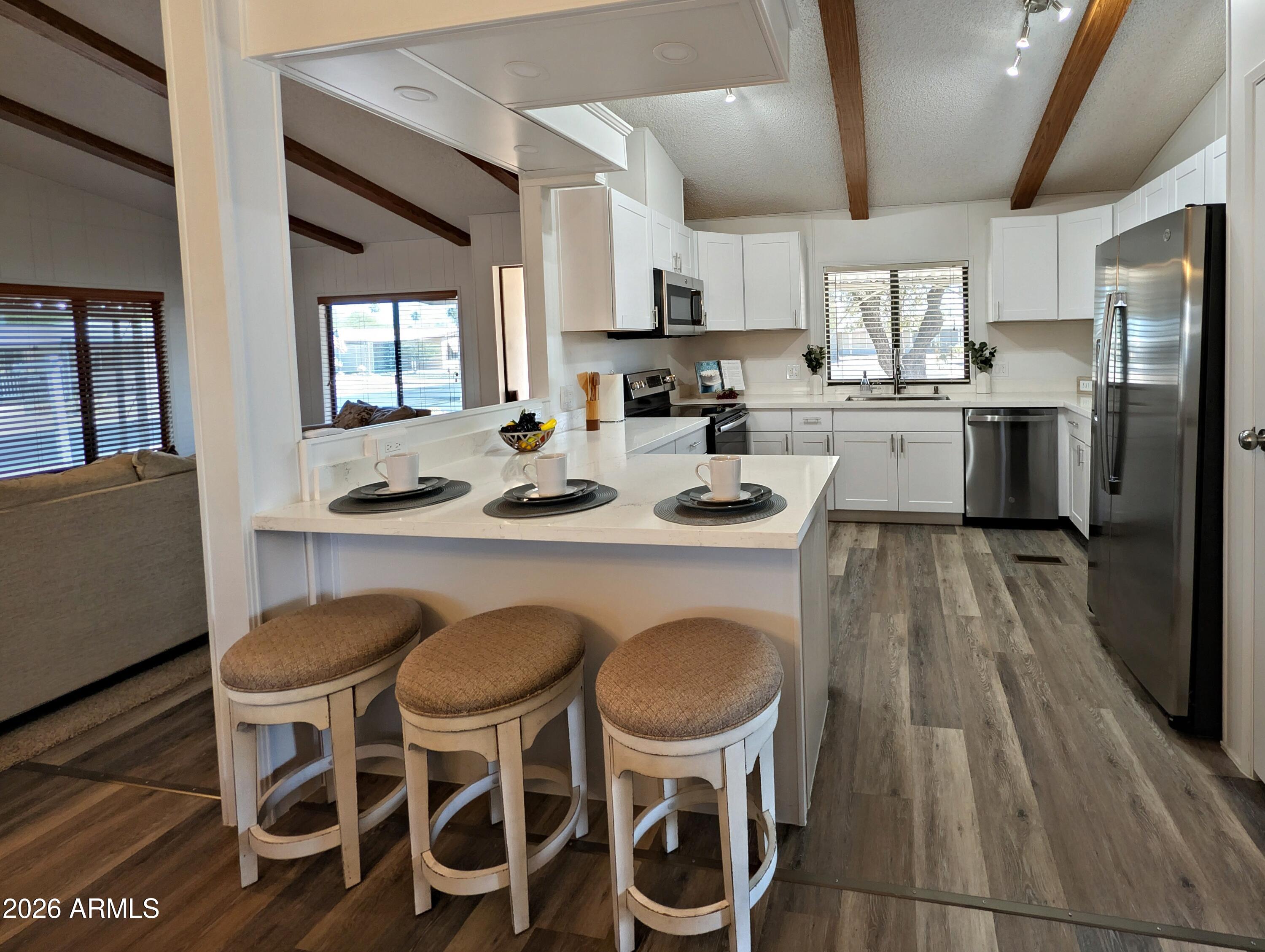 512 South 83rd Way Mesa, AZ 85208 - Photo 20 of 45 a kitchen with granite countertop cabinets and stainless steel appliances